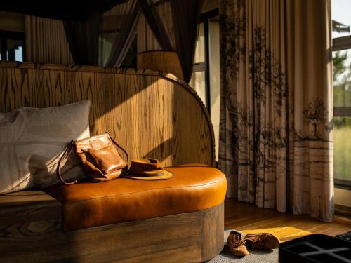 a room with a chair with a hat and shoes at Amaya in Hoedspruit