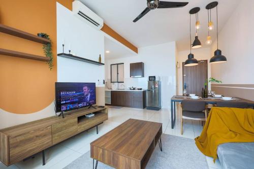 a large living room with a tv and a kitchen at Greenfield Residence Bandar Sunway in Petaling Jaya