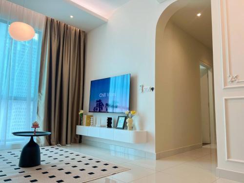 a living room with a large window and a table at Greenfield Residence Bandar Sunway in Petaling Jaya