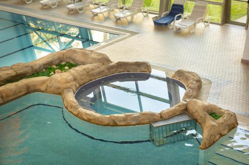 a pool in a building with a water slide at Aqua Fantasy Aquapark Hotel & Spa - Ultra All Inclusive in Kusadası