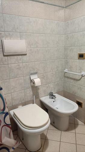 a bathroom with a toilet and a sink at Peace House in Costalta