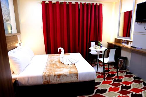 Ένα ή περισσότερα κρεβάτια σε δωμάτιο στο Tanha Park Hotel