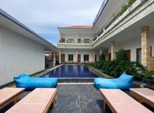 a courtyard with a swimming pool in a house at Canggu Kayuma House in Canggu