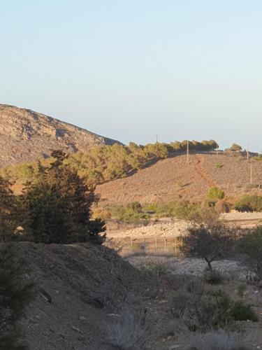 a view of a desert with a hill in the background at Casa SayLavy in El Descargador
