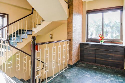 a staircase in a building with a window at Super Collection O Belgacihia Near Kolkata Railway Station in kolkata