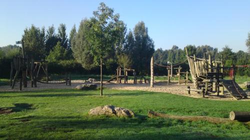 a park with an empty playground with a slide at Nettetal - das kleine Haus am See in Nettetal