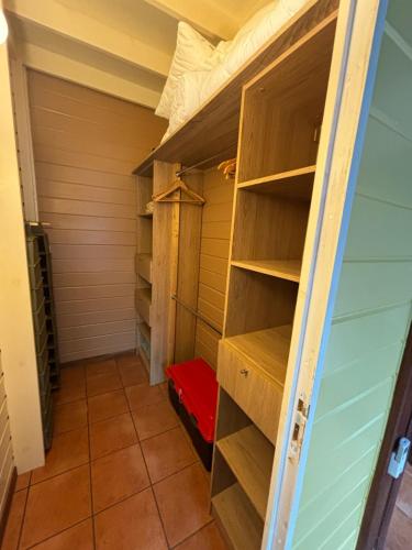 a closet with wooden shelves in a room at villa créole avec piscine privée in Petit-Bourg
