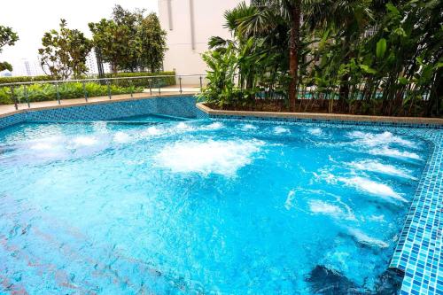 a swimming pool with blue water in a resort at Greenfield Residence Bandar Sunway in Petaling Jaya