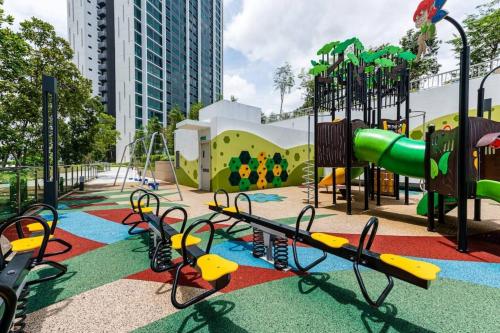 an outdoor playground with a slide and a slideintend at Greenfield Residence Bandar Sunway in Petaling Jaya