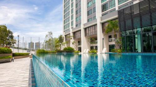 a swimming pool in front of a building at Greenfield Residence Bandar Sunway in Petaling Jaya