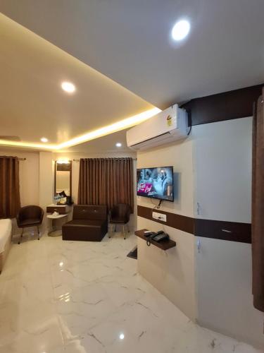 a living room with a couch and a tv in a room at Hotel Royal Mithila Private Limited in Janakpur