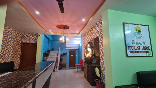 a corridor of a restaurant with a bar and a staircase at Prashaanti Tourist lodge and Restaurant in Bongaigaon