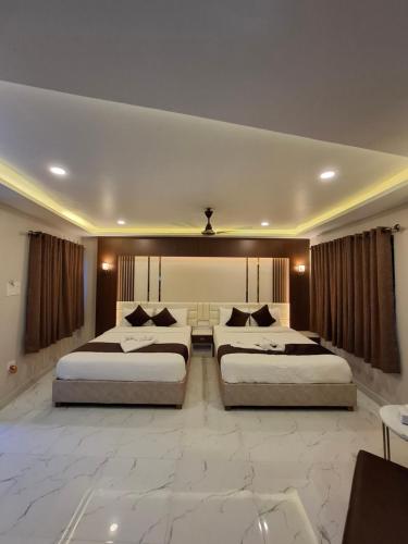 two beds in a hotel room with two bedsvisor at Hotel Royal Mithila Private Limited in Janakpur