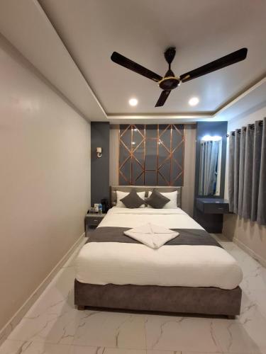 a bedroom with a large bed with a ceiling fan at Hotel Royal Mithila Private Limited in Janakpur