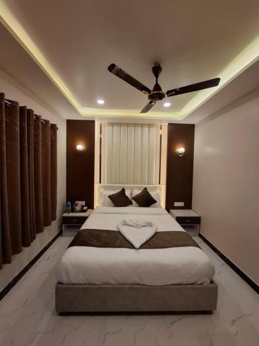 a bedroom with a bed with a heart shaped pillow on it at Hotel Royal Mithila Private Limited in Janakpur