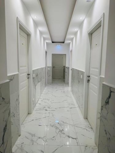 a hallway with marble floors and white walls at Casa Roma in Rome