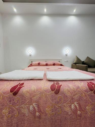 a bedroom with a large bed with a red blanket at Casa Roma in Rome