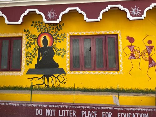 a yellow building with a statue on the side of it at Temple View in Bangalore