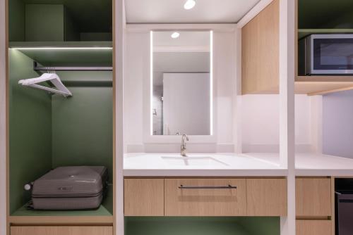 a bathroom with a sink and a mirror at lyf Bondi Junction Sydney in Sydney