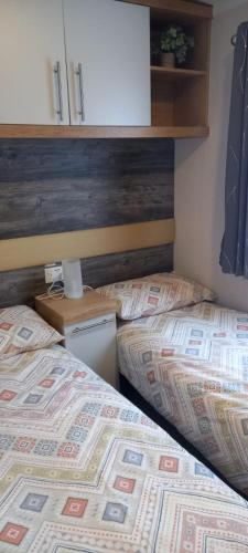 two beds sitting next to each other in a room at Chill Out at Seton Sands in Port Seton