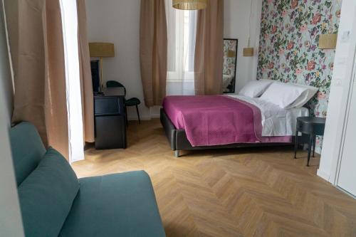 a bedroom with a bed with a purple blanket at La Locanda del Sarto in Belmonte Calabro