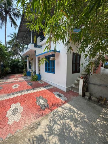 a house with a mosaic walkway in front of it at MOON VILLA 01 varkala 3bhk with kitchen in Varkala