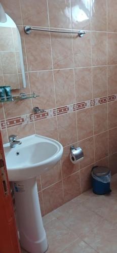a bathroom with a white sink and a mirror at Selin Pansiyon in Kemer