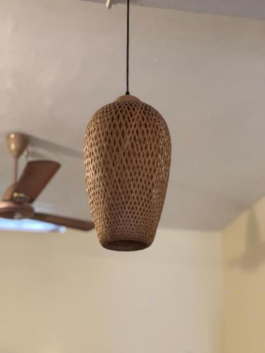 a pendant light hanging from a ceiling at MOON VILLA 01 varkala 3bhk with kitchen in Varkala