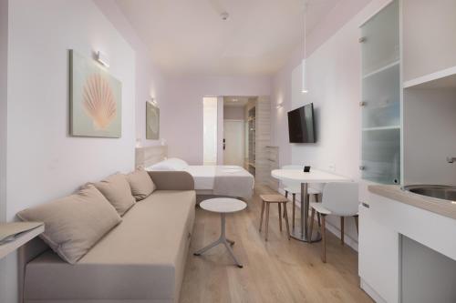 a white living room with a couch and a table at Villa Primordia in Podgora