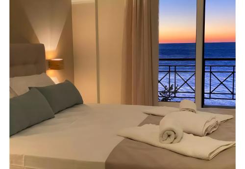 a bedroom with a bed with a view of the ocean at Sunset Premium Studio 12 in Agios Nikitas