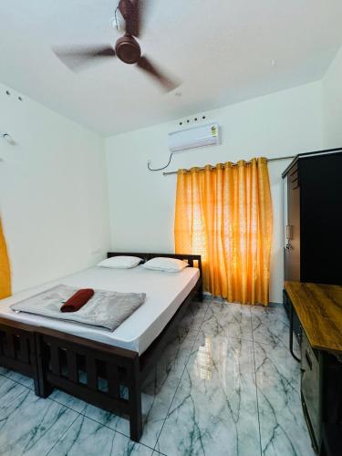 a bedroom with a bed and a ceiling fan at MOON 3bhk ENTIRE VILLA 02 Varkala with kitchen in Varkala