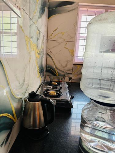 a kitchen with a stove and a tea kettle at MOON 3bhk ENTIRE VILLA 02 Varkala with kitchen in Varkala