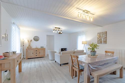 a living room with a couch and a table at Gite du cerisier in Lanouaille