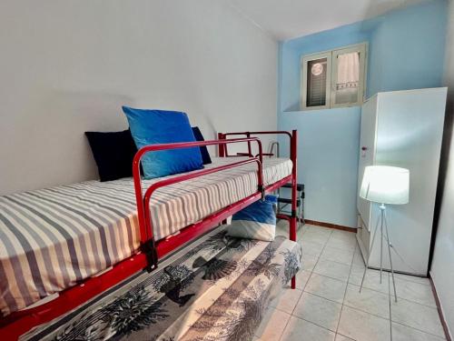 a bedroom with a red bunk bed in a room at Casa dello Rio - Elba Affitti in Rio nellʼElba