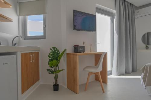 a kitchen with a desk and a chair in a room at Kastraki Riviera in Kastraki Naxou