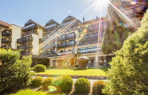 a large building with a garden in front of it at Parkhotel Luise Bad Herrenalb in Bad Herrenalb