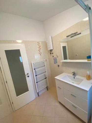 a bathroom with a sink and a mirror at Mobile Homes Camping Biograd in Biograd na Moru