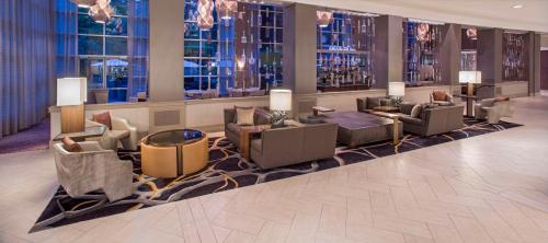 a lobby with couches and chairs in a building at Hyatt Regency Sacramento in Sacramento