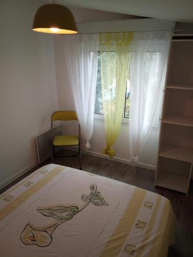 a bedroom with a bed and a window at Maison de village au calme in Saujon