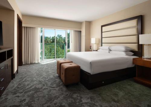 a bedroom with a large bed and a large window at Hyatt Regency Sacramento in Sacramento