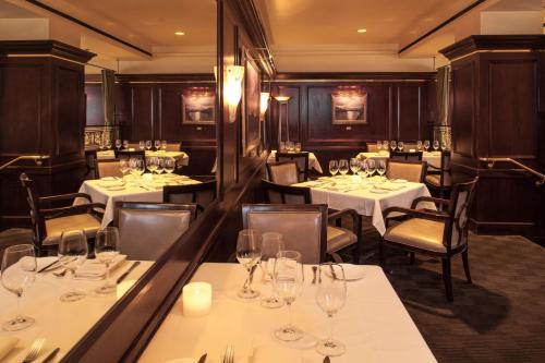 a dining room with tables and chairs with glasses at Hyatt Regency Sacramento in Sacramento