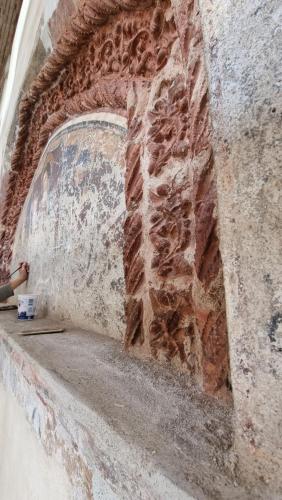 a brick wall with a person standing next to it at Albergo Trieste Boves - Ricetto Suite in Boves