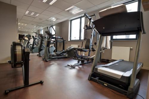 a gym with several tread machines in a row at Apparthotel Privilodges Carré de Jaude in Clermont-Ferrand