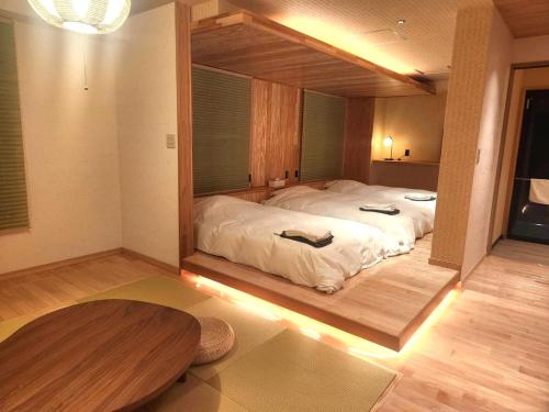 a bedroom with a large bed with a large mirror at ホテル大藏 in Kanoya