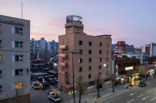 a building with a watch tower on top of it at H Avenue Chuncheon in Chuncheon