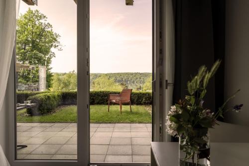 a door leading to a patio with a chair outside at Vranovská pláž - Holiday park in Vranov nad Dyjí