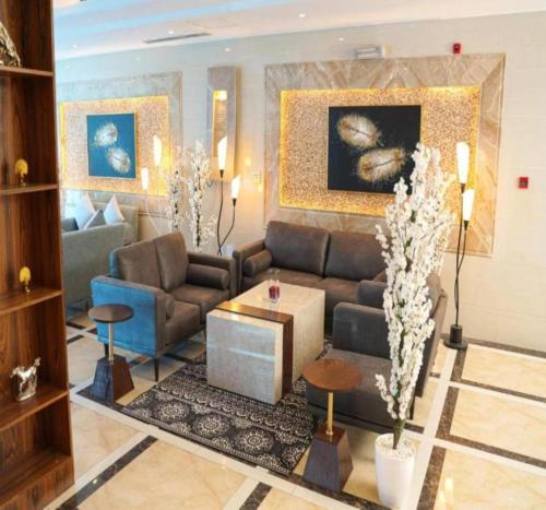 a living room with a couch and a table at Palette Luxury Credi Hotel in Riyadh