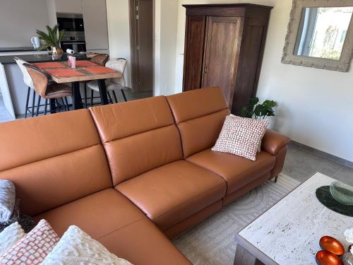 a living room with a brown couch and a table at Aurelia in Ronse