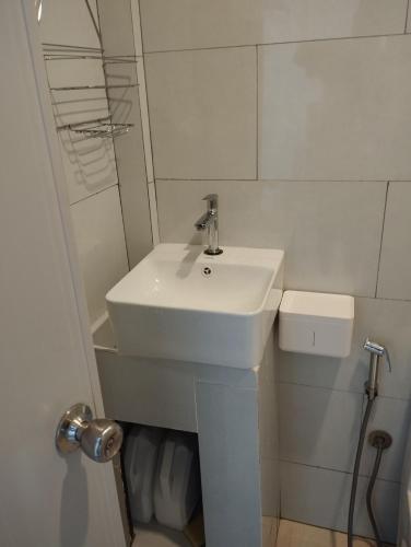 a white bathroom with a sink and a shower at Himandhoo sweet dreams in Himandhoo 
