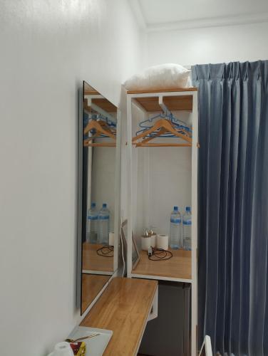 a room with a desk and some water bottles at Himandhoo sweet dreams in Himandhoo 